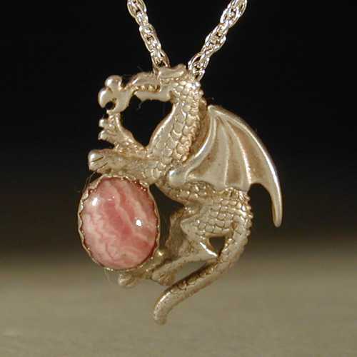 A dragon holds a Rhodochrosite