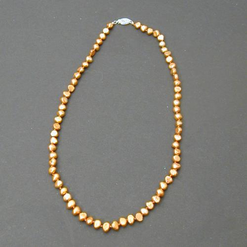 These lovely copper irradiated feshwater pearls are handknotted onto copper colored silk with a 14 kt gold clasp and 14 kt bead tips.